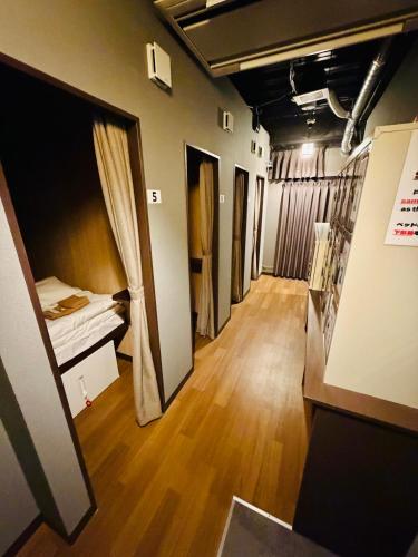 a room with a room with a bed and a hallway at Shinbashi Kon Hotel in Tokyo