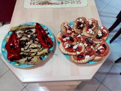 two plates of food sitting on a table at Paraskevi's Luxury Studios in Parga