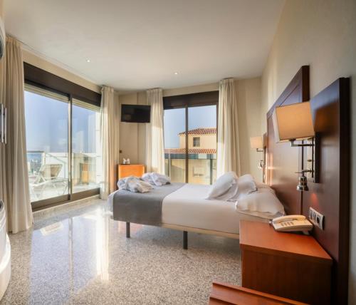 En eller flere senge i et værelse på Moon Dreams Calabahía