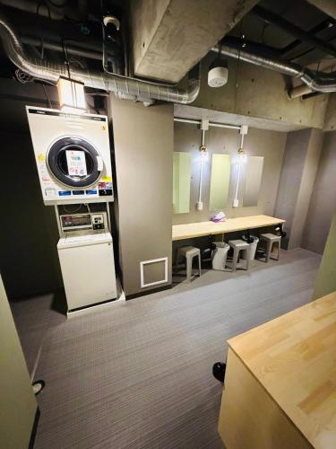 a room with a stage and a table and benches at Shinbashi Kon Hotel in Tokyo