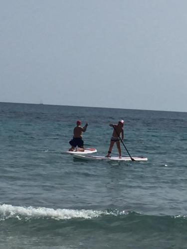 two people on paddle boards in the ocean at SUITEBEACH b&b and resort in Marsala