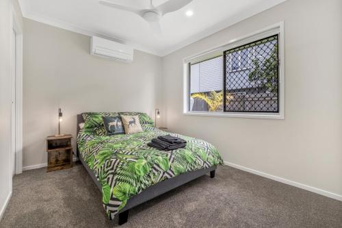 a bedroom with a bed and a window at 3 Bedroom Fully Renovated Home away from Home in Brisbane