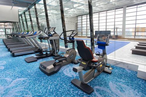 un gimnasio con una fila de bicicletas estáticas y una piscina en Crowne Plaza Beijing Chaoyang U-Town, an IHG Hotel, en Beijing