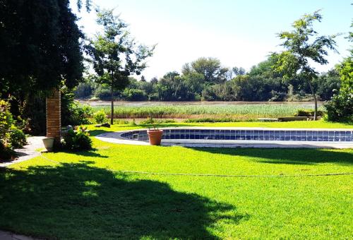 un jardin avec une piscine au milieu de la pelouse dans l'établissement Budler Stay, à Upington