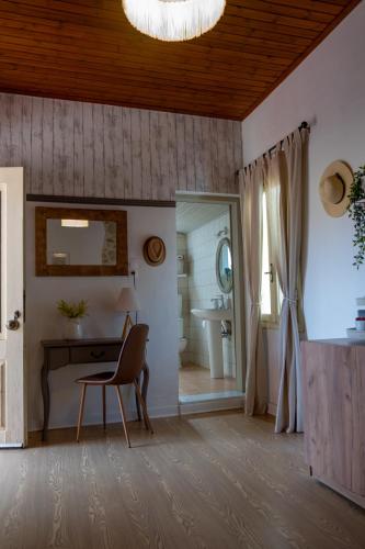 a bathroom with a desk and a mirror and a sink at St Thomas House in Adhráktia