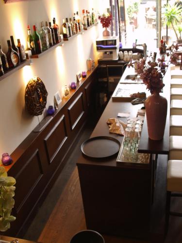 a restaurant with a long counter with bottles on the wall at Hotel Santa Maria in Rotterdam