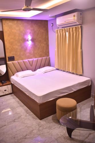 a bedroom with a large bed in a room at HOTEL SHIVAY Inn in Guwahati