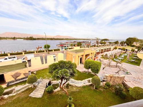 an aerial view of a resort with a body of water at Jewel Luxor Hotel Nile View in Luxor