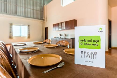 a table set up for a meal in a kitchen at Treebo Pappilon Palace - PVS Circle in Mangalore