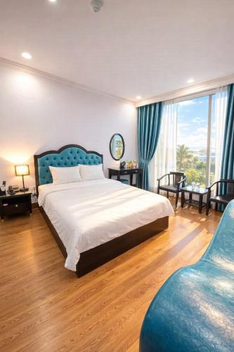 a bedroom with a large bed and a large window at Nhật Tân Hotel in Hanoi