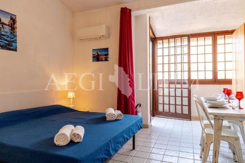 Schlafzimmer mit einem Bett und einem Tisch sowie einem Tisch und Stühlen in der Unterkunft Pesciolino Bianco in Campese