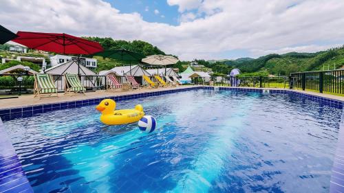 a pool with a rubber duck in the water at Gapyeong Cheongchun Glamping & Caravan in Gapyeong