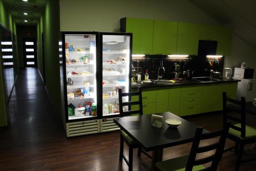 a kitchen with a refrigerator filled with lots of food at PLED Hostel Samotechnaya in Moscow