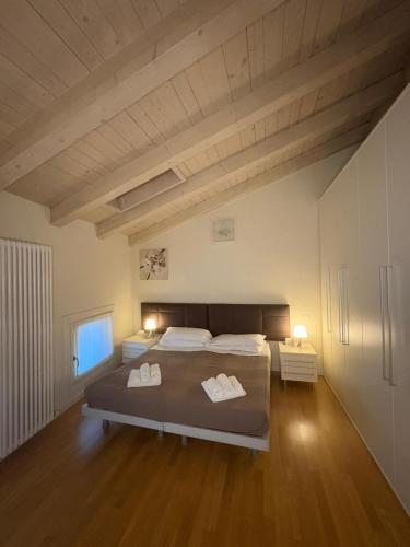 a bedroom with a large bed with two towels on it at Corte Trambai in Gambellara