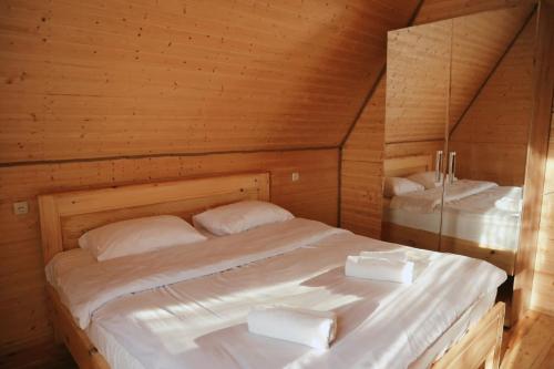 a bedroom with a large bed in a wooden room at Ranch in Variani in Variani