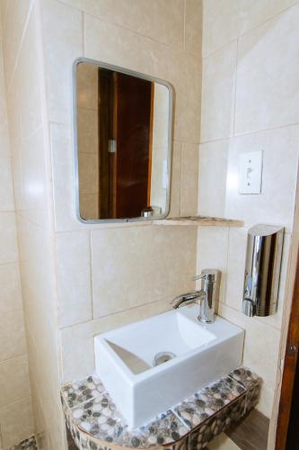 a bathroom with a white sink and a mirror at Departamento centrico con estacionamiento WiFi in Matamoros