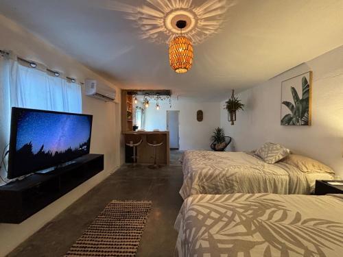 a bedroom with two beds and a flat screen tv at Apartment #3 for 4 WiFi-centric-consulate in Matamoros