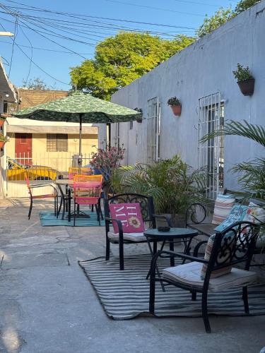 a group of chairs and tables with an umbrella at Apartment #3 for 4 WiFi-centric-consulate in Matamoros