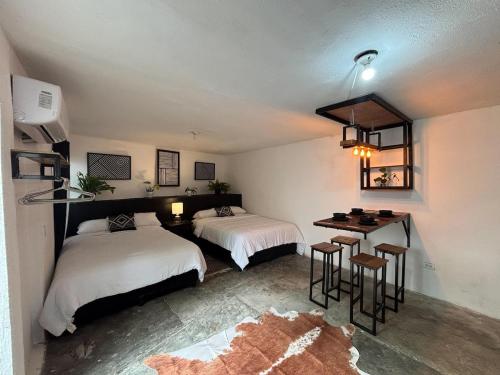 a bedroom with two beds and a table and chairs at Apartment #4 for 4 Central-WiFi-consulate in Matamoros