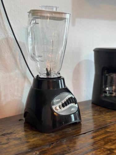 a black blender sitting on top of a wooden table at Apartment #4 for 4 Central-WiFi-consulate in Matamoros
