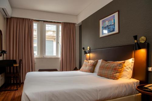 En eller flere senge i et værelse på WOT Porto Soul