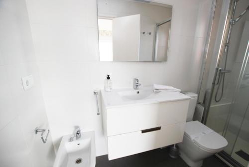 a bathroom with a sink and a toilet and a mirror at Narciso views in Vilassar de Mar