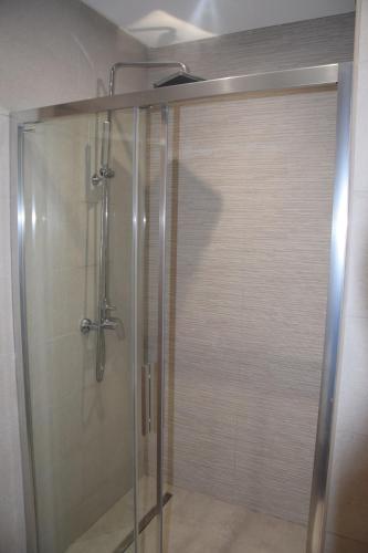 a shower with a glass door in a bathroom at Fantastic Appartment SeaView Sousse in Akouda