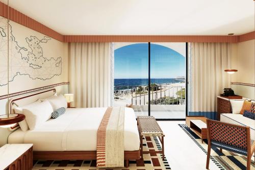 a bedroom with a bed and a view of the ocean at Vasia Resort & Spa in Sissi