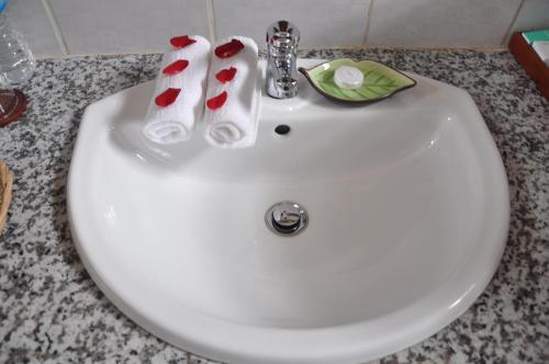 a white sink with two pairs of socks on it at Trinity Family Inn in Nyaung Shwe