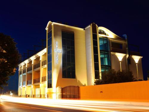 a building at night with a street in front of it at Hotel Napoleon in Torre Melissa