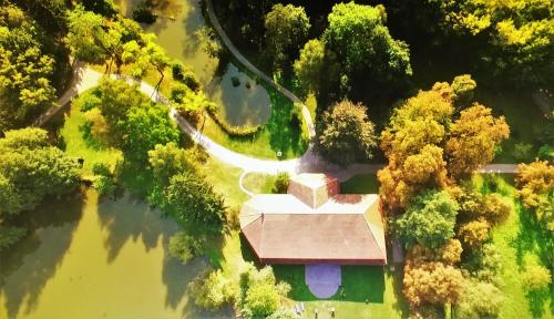 an aerial view of a house in the middle of a river at Zabola Estate - Transylvania in Zăbala