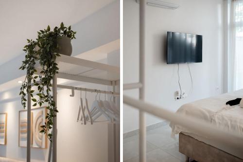 Luxury Kingbed Studio - Estia Premium Apartments في سلانيك: غرفة بها سرير وتلفزيون على الحائط