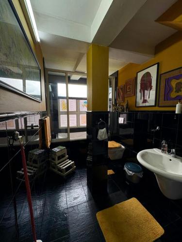 a large bathroom with a sink and a tub at Rugby House Kandy in Kandy