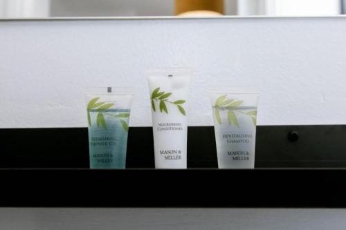 un groupe de quatre produits posés sur une étagère dans l'établissement NEWLY Refurbed - Large Studio Apt With Private Parking, à Exeter