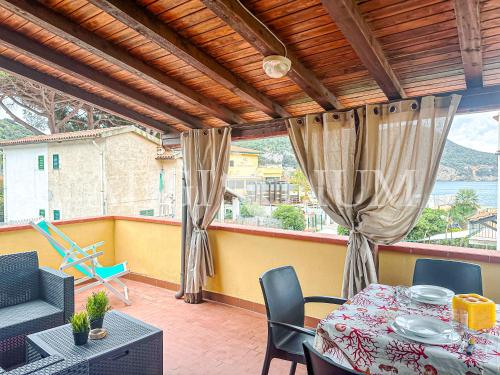 Zimmer mit einem Tisch und Stühlen auf einem Balkon in der Unterkunft Maria Vittoria in Campese