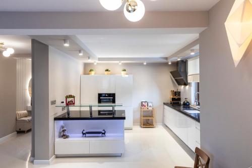 a kitchen with white cabinets and a counter top at TatryTop Dom Tatra Home Residence Jacuzzi in Biały Dunajec