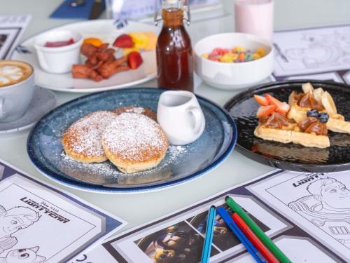 a table with plates of pastries and other breakfast foods at Novotel Medellin El Tesoro in Medellín