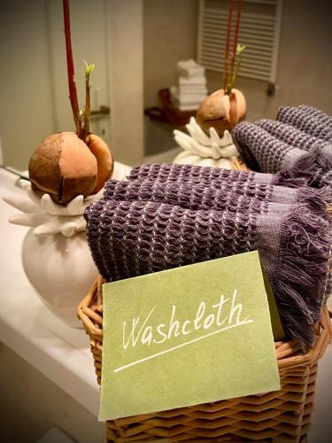a basket of towels on a counter with a sign at The olive tree vacation home in Colico in Colico
