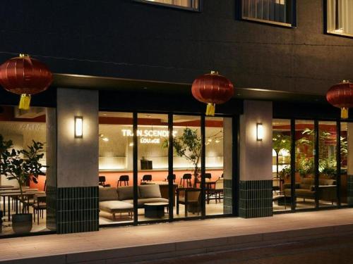 a restaurant with red lanterns on the side of a building at TRANSCENDER HOTEL Yokohama in Yokohama