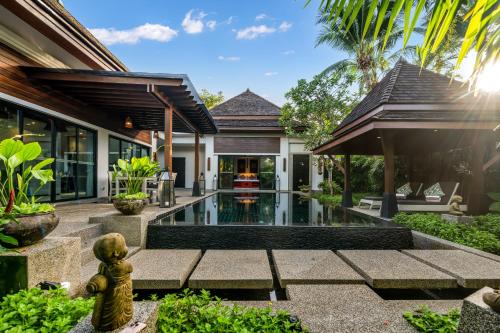 an external view of a villa with a swimming pool at The Bell Pool Villa Resort Phuket in Kamala Beach