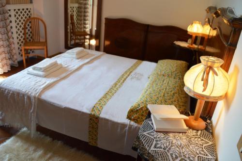 a bedroom with a bed and a table with a book at Casa Furletti Holiday Home in Tenno