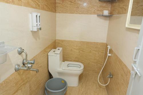 a bathroom with a toilet and a sink at Prakash Nilayam Studio I - Kondapur in Lingampalli
