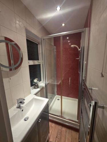 a bathroom with a shower and a sink and a shower at The Nook in Taunton