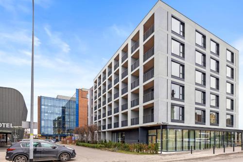 a building with a car parked in front of it at City Break Śląska 8 by INA in Gdańsk