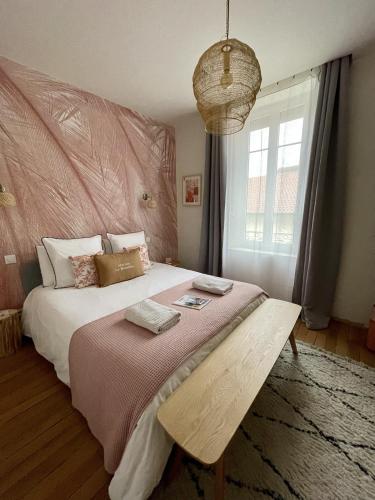 a bedroom with a large bed with a large window at Maison Le Beaulieu in Vichy