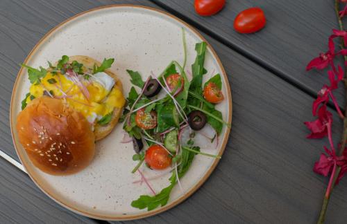 a plate of food with a sandwich and salad at Thong Dong Quán Boutique Hotel Hue in Hue