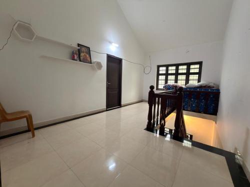 a room with a hallway with a chair and a door at Dream House Near IIM Kozhikode & NIT Calicut in Kozhikode