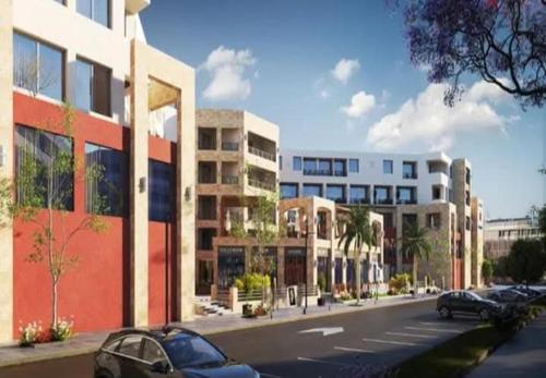 een weergave van een straat met auto's geparkeerd voor gebouwen bij Luxury Studio, pool, Private beach & close to Airport in Hurghada