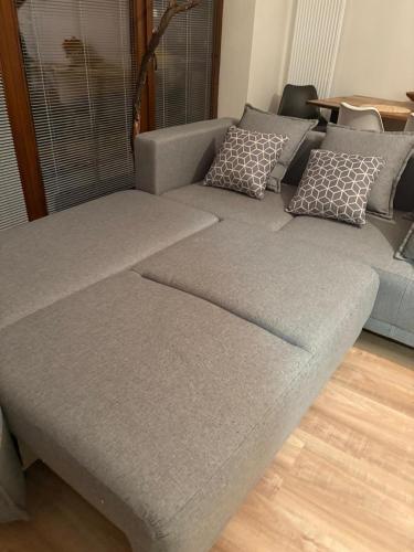 a couch with pillows on it in a living room at Riverside Vrchlabí in Vrchlabí