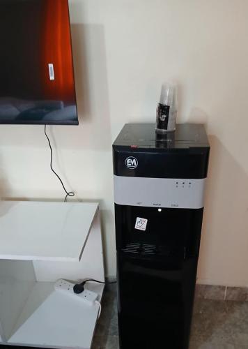 a black and white computer tower next to a wall at Haven Nest in Machakos